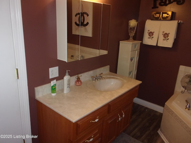 1366 Greens Chapel Rd, Bloomfield, KY 40008 - bathroom featuring vanity, a bath, and wood finished floors