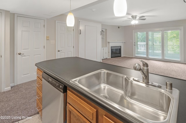 2726 Hollywood Ter Apt 101, Louisville, KY 40206 - kitchen with dishwasher, light colored carpet, dark countertops, brown cabinets, and a ceiling fan