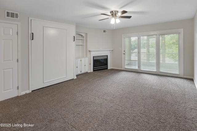 2726 Hollywood Ter Apt 101, Louisville, KY 40206 - unfurnished living room featuring a ceiling fan, carpet flooring, and a glass covered fireplace