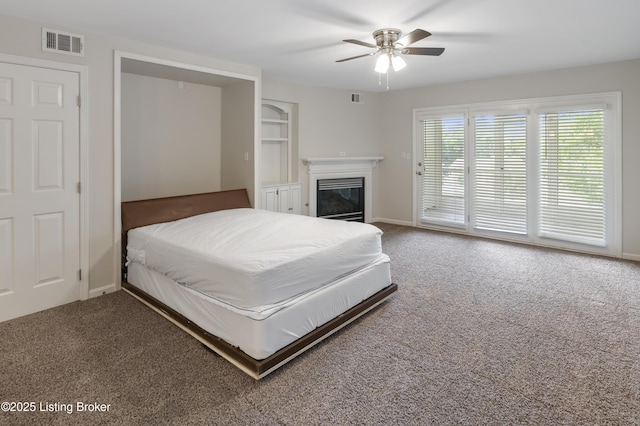 2726 Hollywood Ter Apt 101, Louisville, KY 40206 - bedroom featuring carpet floors, access to exterior, a glass covered fireplace, and ceiling fan