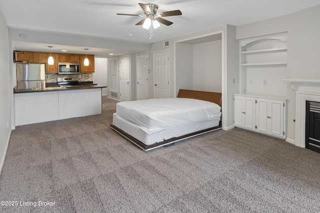 2726 Hollywood Ter Apt 101, Louisville, KY 40206 - bedroom featuring freestanding refrigerator, carpet floors, a glass covered fireplace, and recessed lighting