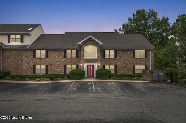 2726 Hollywood Ter Apt 101, Louisville, KY 40206 - view of front of property with uncovered parking, brick siding, and a gate