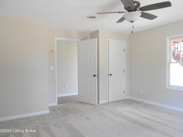 732 Poplar Flat Rd, Bardstown, KY 40004 - unfurnished bedroom with light colored carpet, a ceiling fan, and a closet