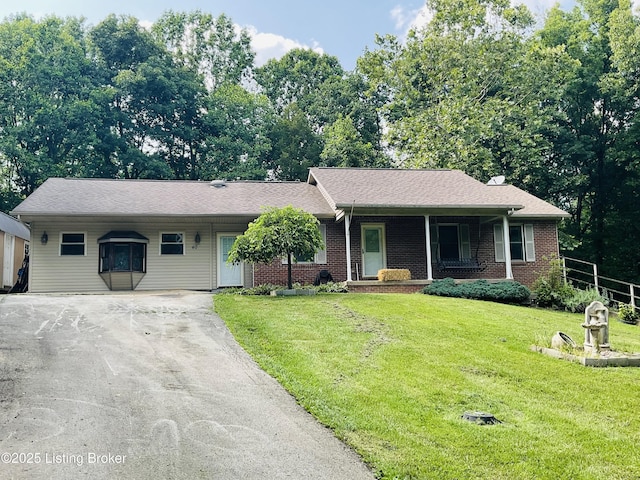 40 Sunflower Ln, Brandenburg, KY 40108 - single story home featuring asphalt driveway, covered porch, a front lawn, and brick siding
