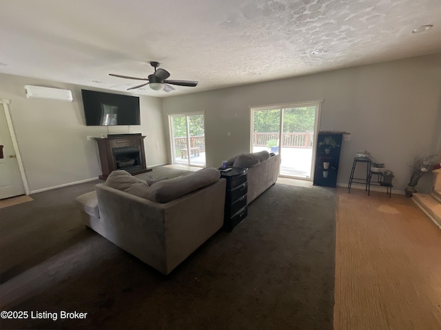 40 Sunflower Ln, Brandenburg, KY 40108 - living room featuring an AC wall unit, a ceiling fan, a fireplace, dark colored carpet, and a textured ceiling