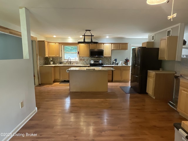40 Sunflower Ln, Brandenburg, KY 40108 - kitchen featuring stainless steel appliances, a center island, light wood-type flooring, tasteful backsplash, and light countertops