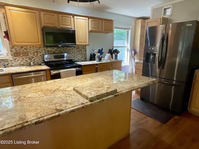 40 Sunflower Ln, Brandenburg, KY 40108 - kitchen featuring stainless steel appliances, wood finished floors, decorative backsplash, and light stone counters