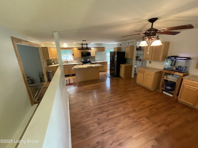 40 Sunflower Ln, Brandenburg, KY 40108 - kitchen with black appliances, a kitchen island, decorative backsplash, dark wood-type flooring, and a ceiling fan