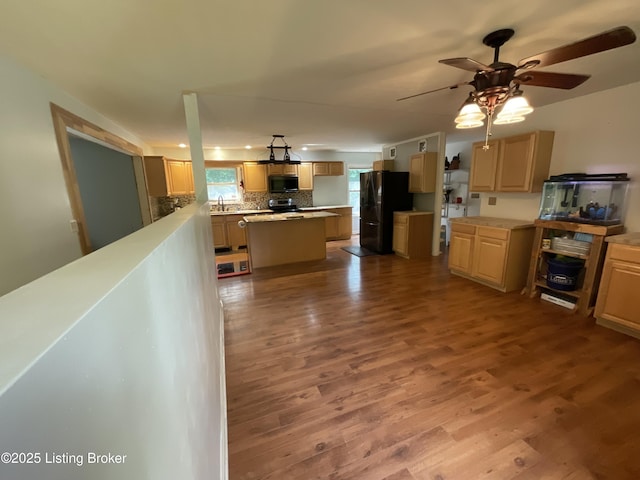 40 Sunflower Ln, Brandenburg, KY 40108 - kitchen featuring black appliances, wood finished floors, tasteful backsplash, a ceiling fan, and a center island