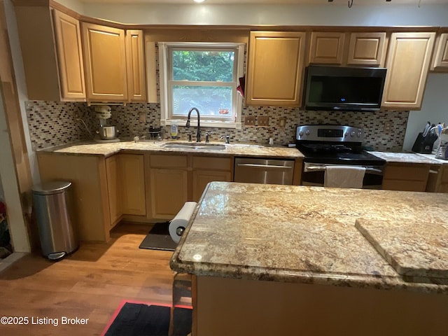 40 Sunflower Ln, Brandenburg, KY 40108 - kitchen with stainless steel appliances, light wood-style floors, backsplash, light brown cabinetry, and light stone countertops