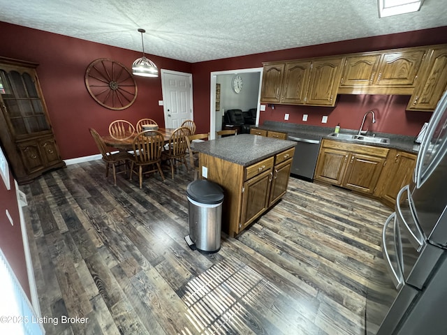 79 Brightberry Rd, Brandenburg, KY 40108 - kitchen featuring stainless steel dishwasher, dark countertops, freestanding refrigerator, dark wood-style flooring, and a center island