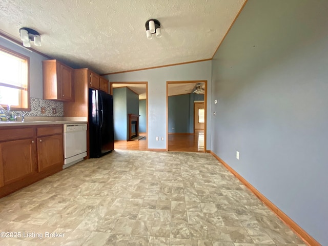 356 Armes Lively Rd, Leitchfield, KY 42754 - kitchen with white dishwasher, freestanding refrigerator, brown cabinetry, a textured ceiling, and light countertops