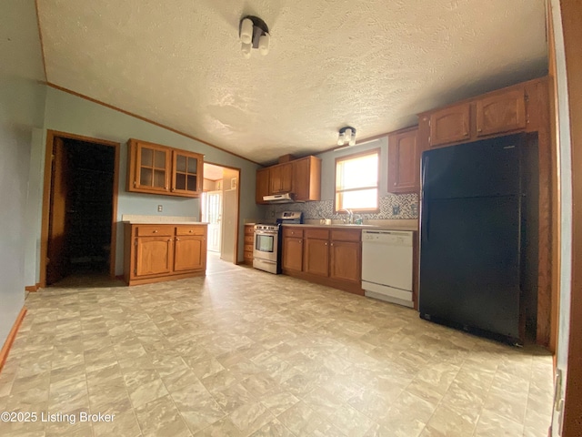 356 Armes Lively Rd, Leitchfield, KY 42754 - kitchen with white dishwasher, freestanding refrigerator, stainless steel range, brown cabinets, and light countertops