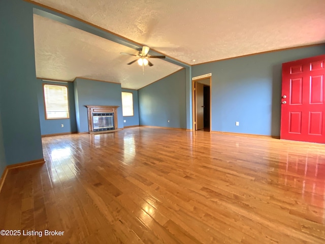 356 Armes Lively Rd, Leitchfield, KY 42754 - unfurnished living room featuring a textured ceiling, a ceiling fan, wood finished floors, and a glass covered fireplace