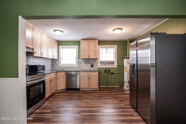 218 N Mantle Ave, Elizabethtown, KY 42701 - kitchen featuring appliances with stainless steel finishes, light brown cabinetry, exhaust hood, dark wood-style flooring, and a textured ceiling