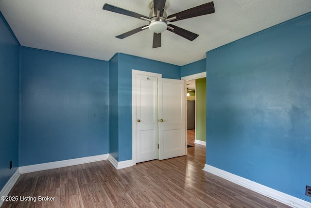 218 N Mantle Ave, Elizabethtown, KY 42701 - unfurnished bedroom with wood finished floors, a ceiling fan, and a textured ceiling