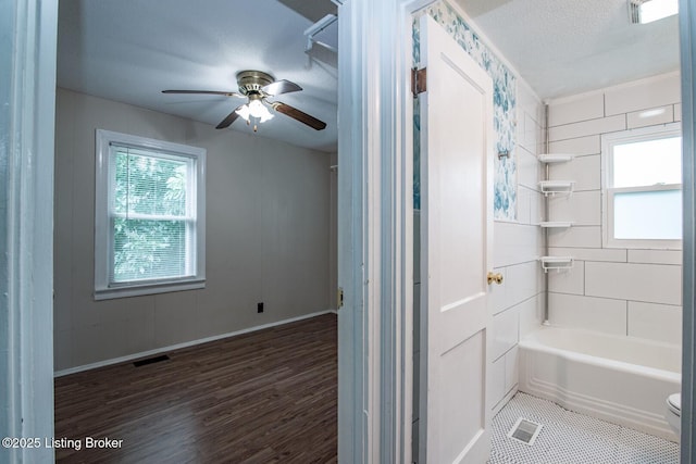 218 N Mantle Ave, Elizabethtown, KY 42701 - bathroom with wood finished floors, ceiling fan, tub / shower combination, and a textured ceiling