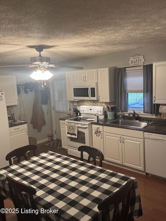 936 Old Ekron Rd, Brandenburg, KY 40108 - kitchen featuring white appliances, a textured ceiling, white cabinets, dark countertops, and ceiling fan