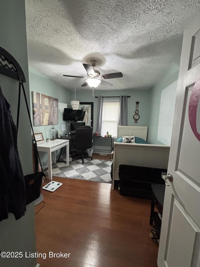 936 Old Ekron Rd, Brandenburg, KY 40108 - bedroom featuring a desk, wood finished floors, a textured ceiling, and a ceiling fan