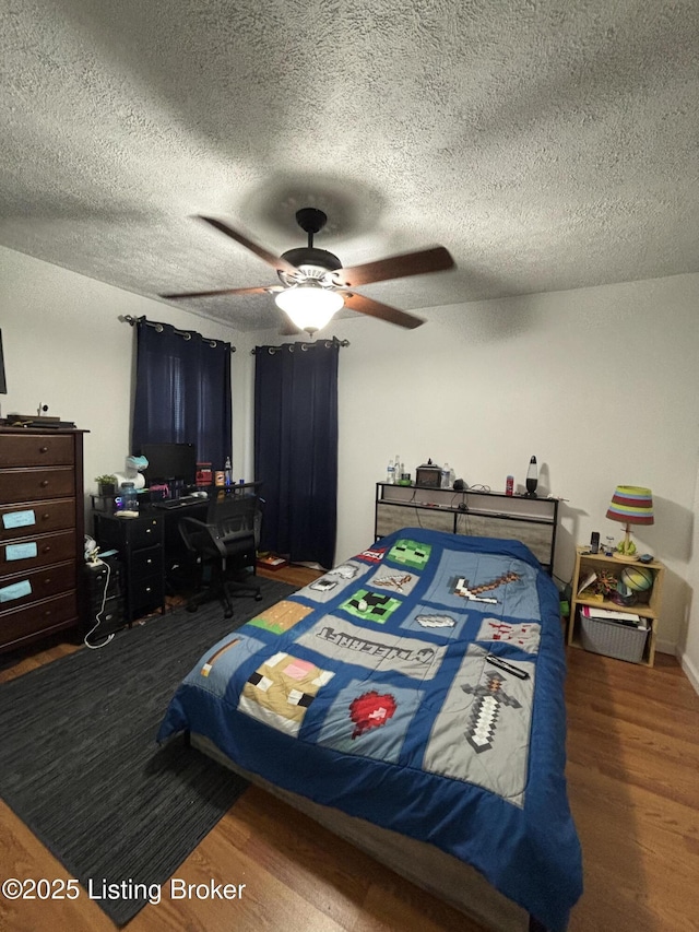 936 Old Ekron Rd, Brandenburg, KY 40108 - bedroom with wood finished floors, an office area, a textured ceiling, and a ceiling fan