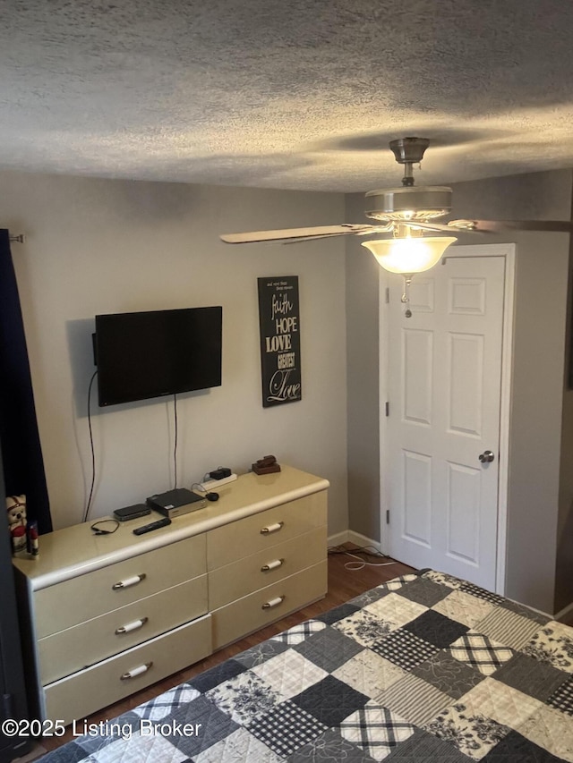 936 Old Ekron Rd, Brandenburg, KY 40108 - bedroom with a textured ceiling, ceiling fan, and dark wood finished floors