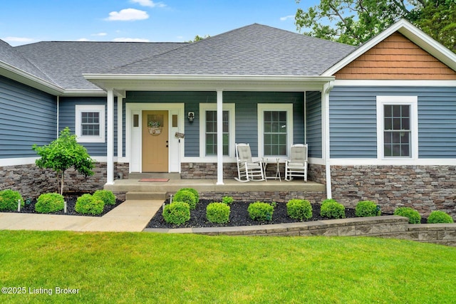 90 Glenn Eagle Rd, Brandenburg, KY 40108 - view of front of property with a porch, a front lawn, roof with shingles, and stone siding