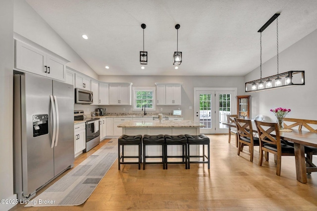 90 Glenn Eagle Rd, Brandenburg, KY 40108 - kitchen with appliances with stainless steel finishes, light wood-style floors, pendant lighting, a kitchen island, and white cabinetry