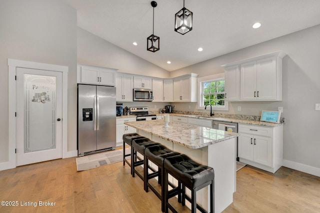 90 Glenn Eagle Rd, Brandenburg, KY 40108 - kitchen with stainless steel appliances, white cabinetry, light wood finished floors, recessed lighting, and high vaulted ceiling