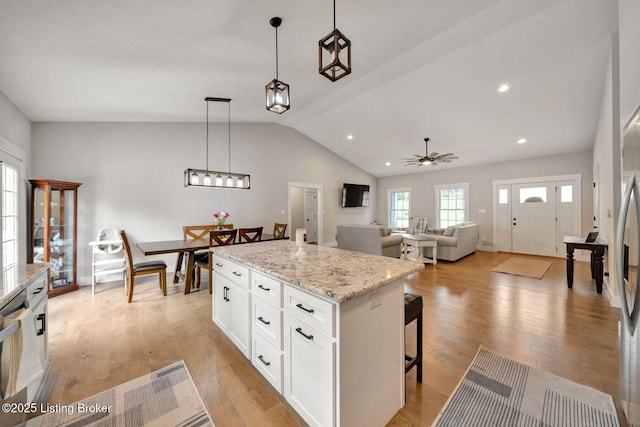 90 Glenn Eagle Rd, Brandenburg, KY 40108 - kitchen with lofted ceiling, ceiling fan, a breakfast bar area, white cabinets, and light wood-type flooring