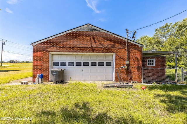 2904 State Route 58 E, Mayfield, KY 42066 - view of side of home with a garage, brick siding, and driveway