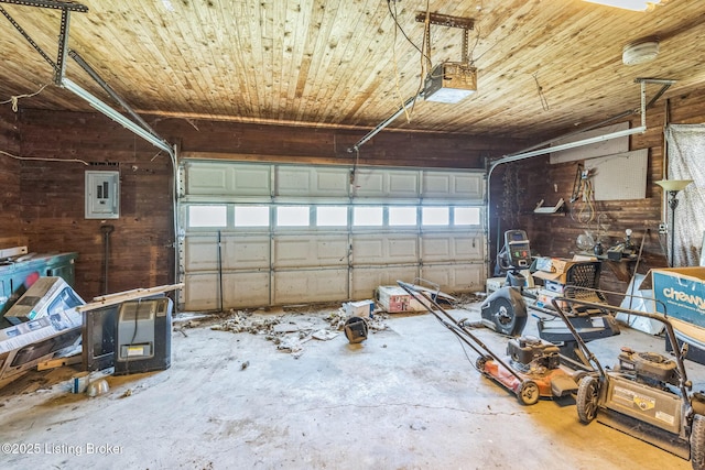 2904 State Route 58 E, Mayfield, KY 42066 - garage featuring electric panel, wooden ceiling, a garage door opener, and wood walls