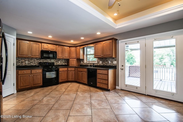 515 Clymene Rd, Cecilia, KY 42724 - kitchen featuring dark countertops, black appliances, tasteful backsplash, brown cabinets, and ceiling fan