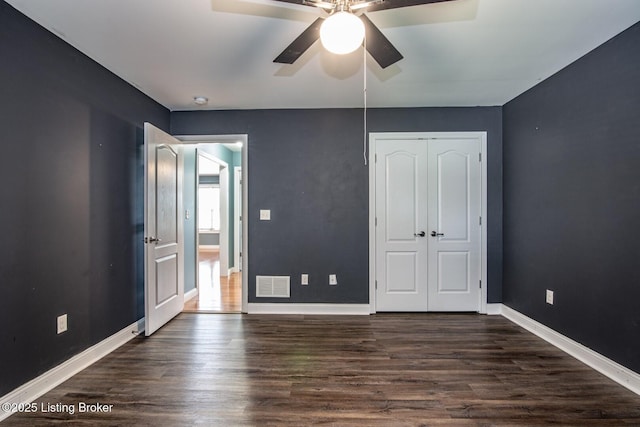 515 Clymene Rd, Cecilia, KY 42724 - unfurnished bedroom with dark wood-style floors, a closet, and a ceiling fan