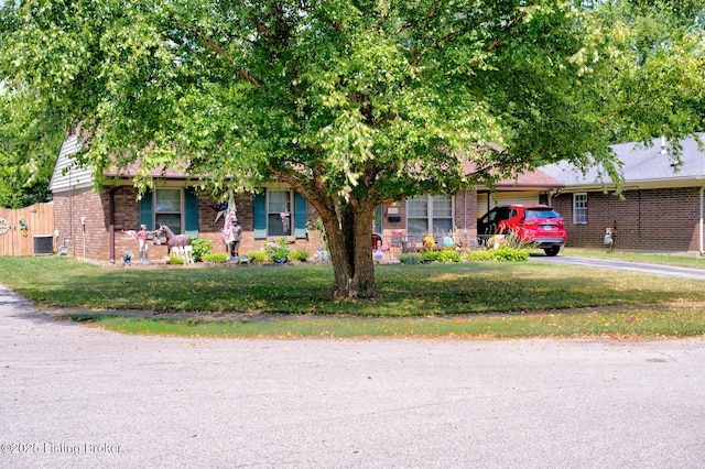 3308 Mcadams Ct, Jeffersontown, KY 40299 - view of property hidden behind natural elements featuring brick siding, a front lawn, and driveway