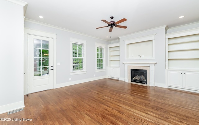 9403 Delphinium St Unit 101, Prospect, KY 40059 - unfurnished living room featuring crown molding, wood finished floors, a fireplace with flush hearth, a ceiling fan, and built in features
