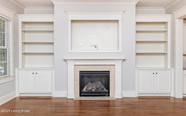 9403 Delphinium St Unit 101, Prospect, KY 40059 - unfurnished living room featuring healthy amount of natural light, wood finished floors, built in shelves, and ornamental molding