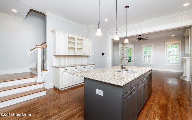 9403 Delphinium St Unit 101, Prospect, KY 40059 - kitchen with white cabinets, ornamental molding, dark wood finished floors, an island with sink, and light stone countertops