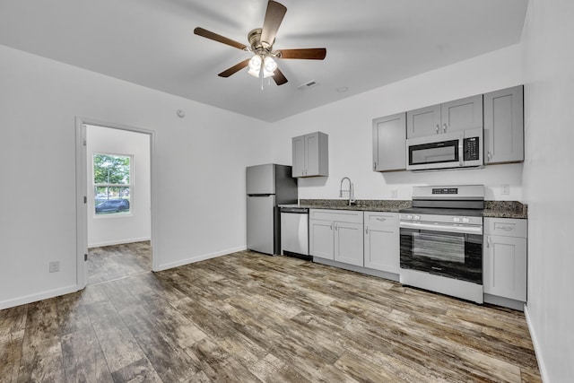 kitchen with baseboards, visible vents, appliances with stainless steel finishes, dark wood-type flooring, and gray cabinets