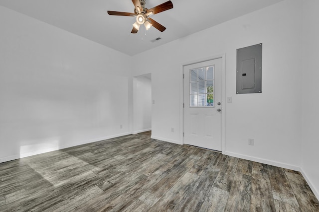 interior space with electric panel, baseboards, visible vents, ceiling fan, and wood finished floors