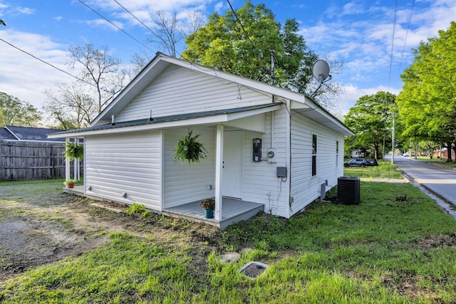 back of house featuring a yard, central AC, and fence