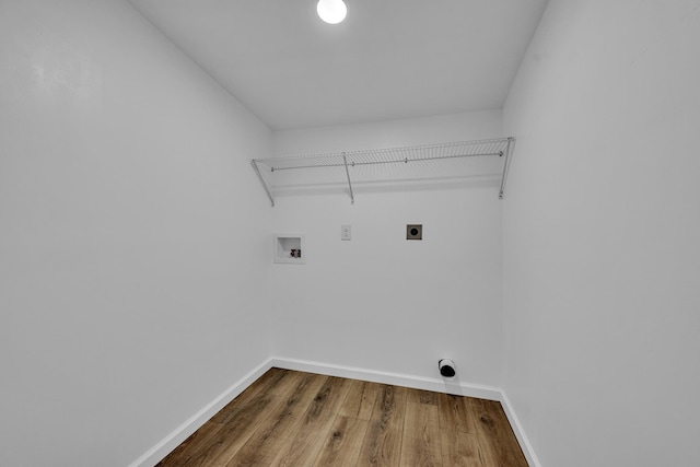 laundry room with laundry area, wood finished floors, electric dryer hookup, and baseboards
