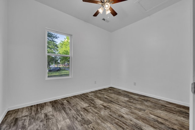 spare room featuring visible vents, baseboards, and wood finished floors