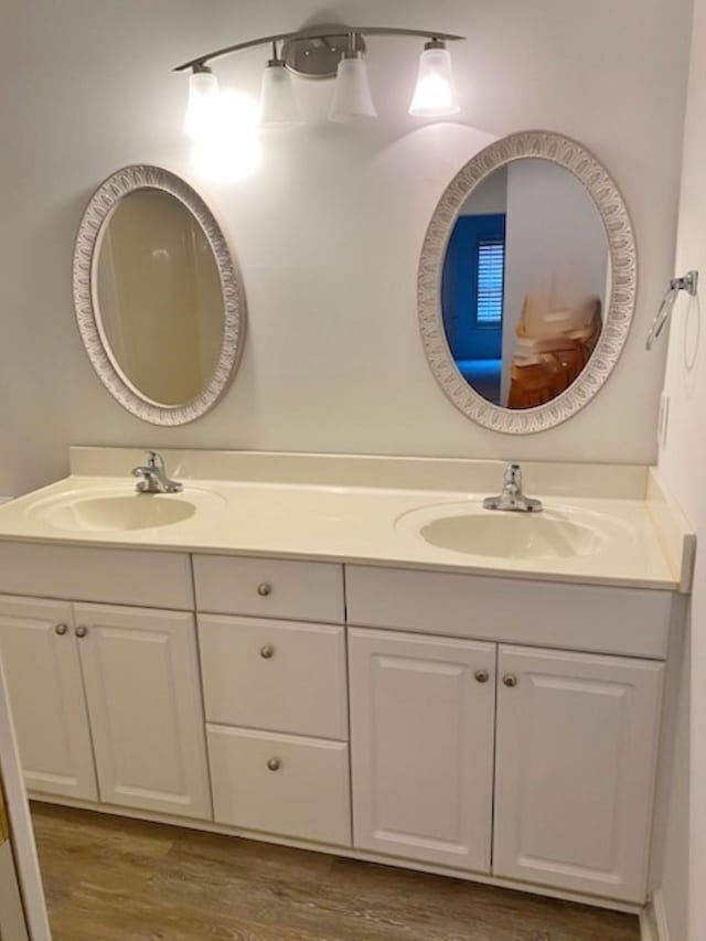 bathroom with vanity and wood-type flooring