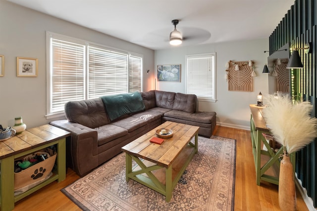  - living area with a ceiling fan and light wood-style floors