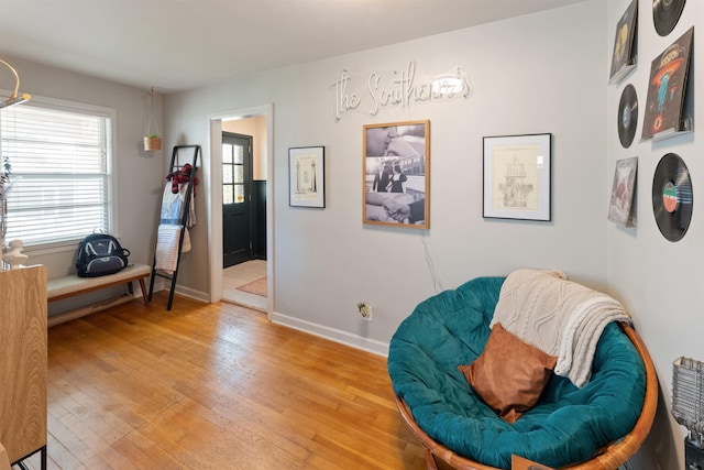  - living area featuring light wood finished floors and baseboards