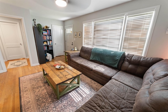  - living area with wood finished floors and ceiling fan