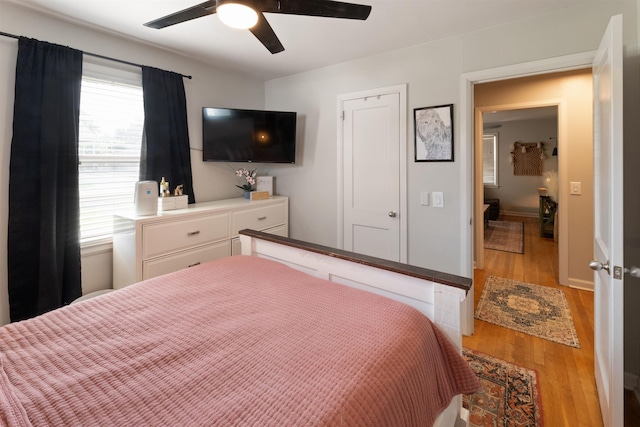 - bedroom with wood finished floors and a ceiling fan