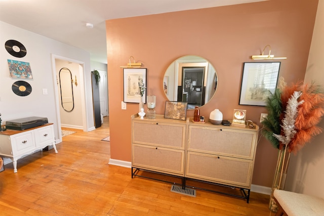  - corridor featuring light wood-style flooring and baseboards