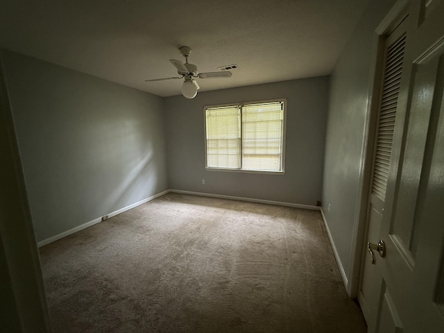  - carpeted spare room featuring ceiling fan and baseboards