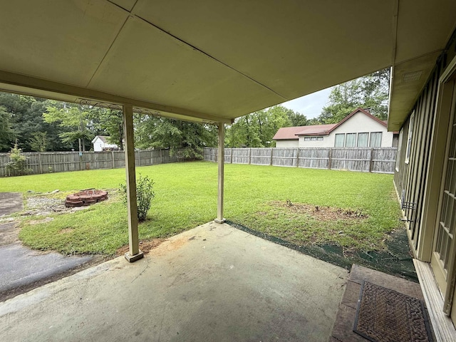  - fenced backyard with a patio and a fire pit